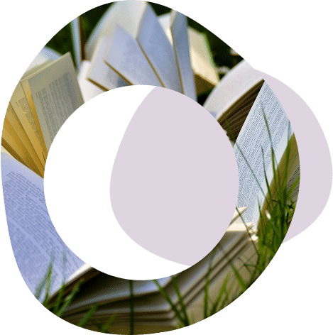 Abstract circles and image of open books lying on grass