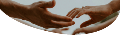 Two people's hands reaching out to each other in a friendly manner