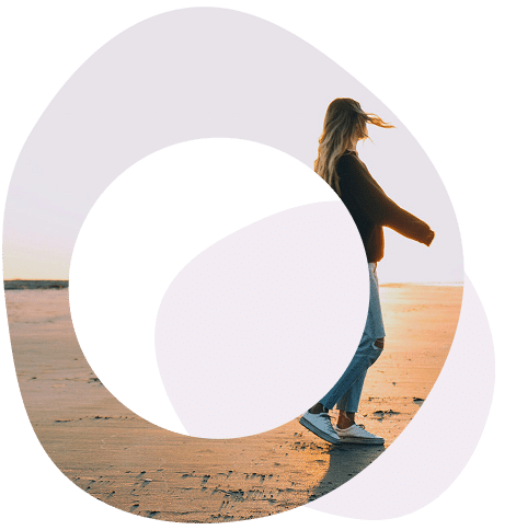 Abstract circles image of lady walking on a beach, wearing a baseball hat