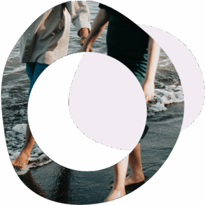 Abstract circles image of two people holding hands and walking along the sea shore