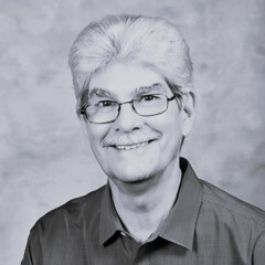 Radical Forgiveness Dr Gary Cone. Wearing glasses, smiling.