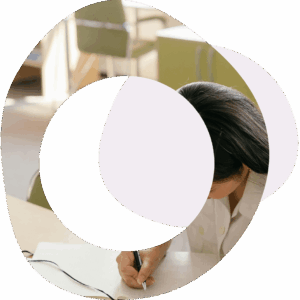 Abstract circles and image of a lady working at a desk and writing in a book