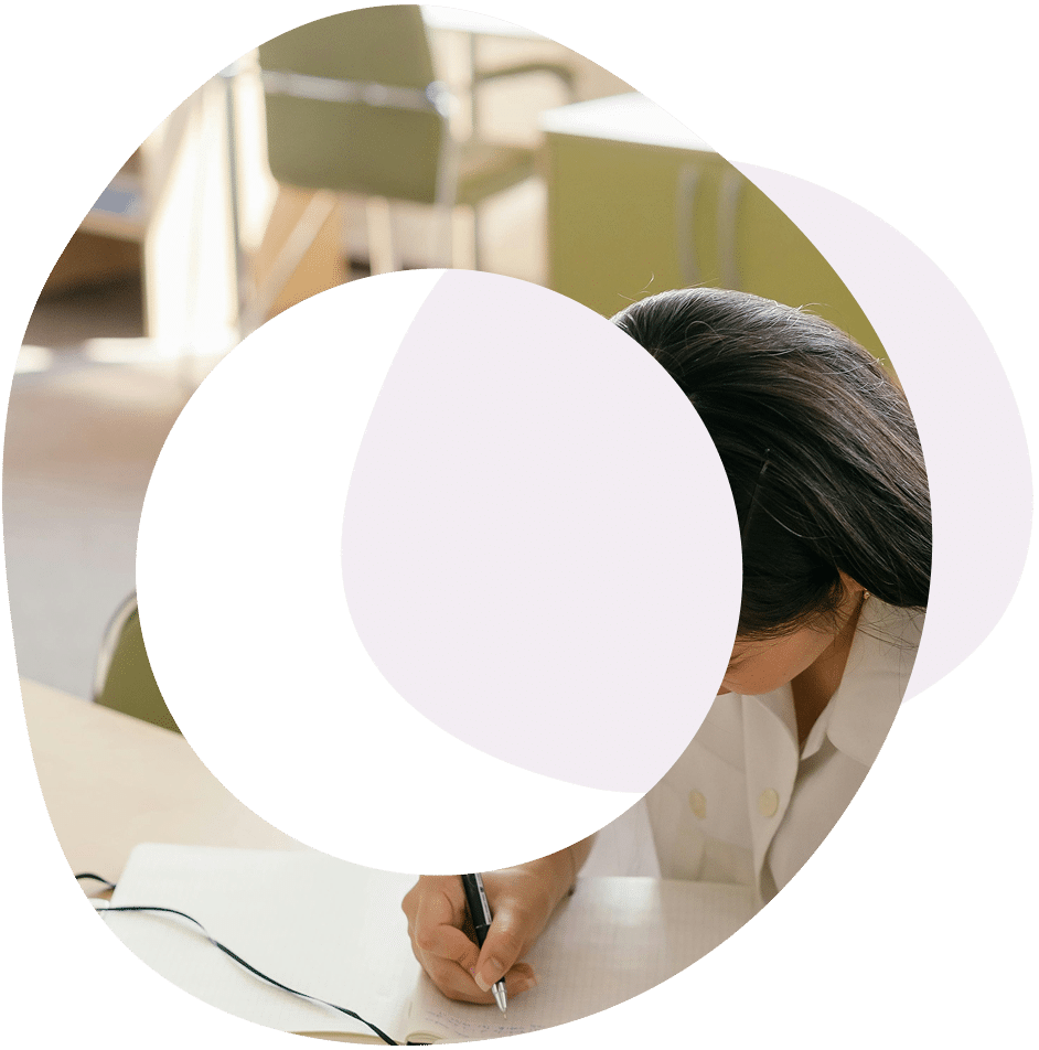 Abstract circles and image of a lady working at a desk and writing in a book