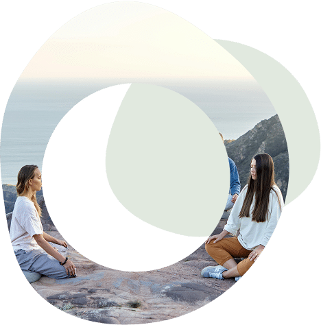 Abstract circle images of a group of people sitting in a circle on the top of a cliff