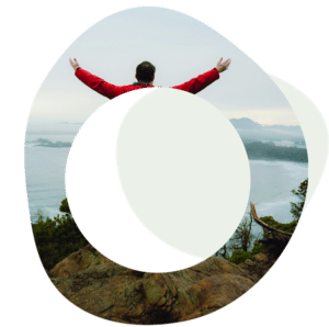 Abstract image of a person with their arms outstretched in the air and they are looking towards a lake
