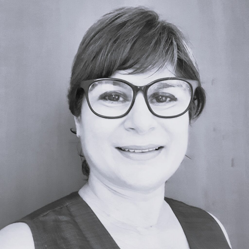 Coach Smriti with short hair, wearing spectacles.