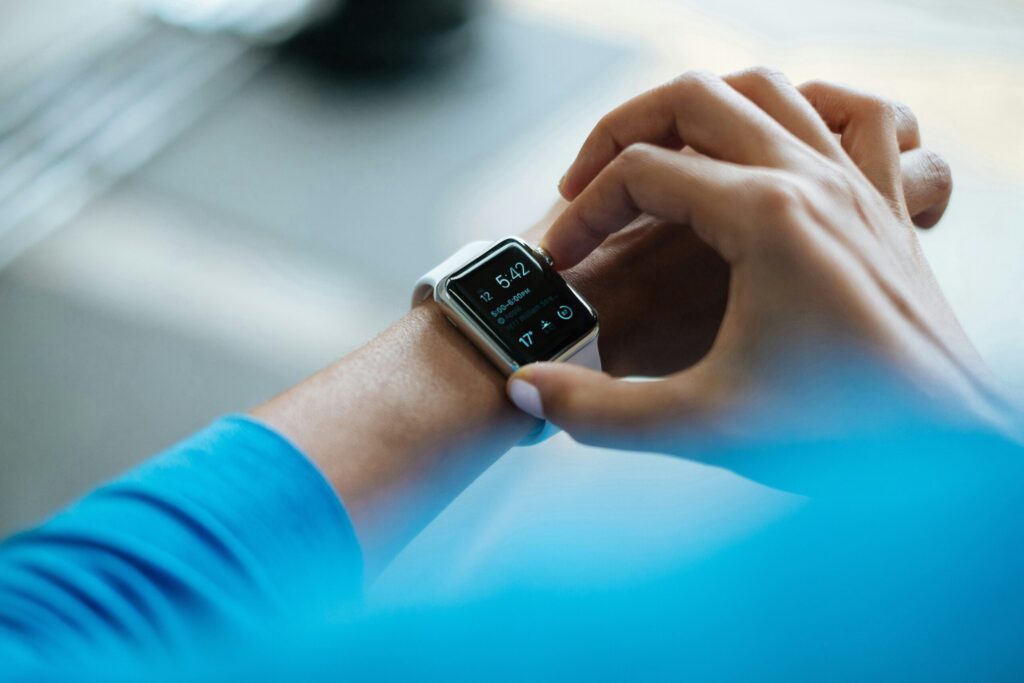 A female holding the controls and checking the readings on her fitness watch