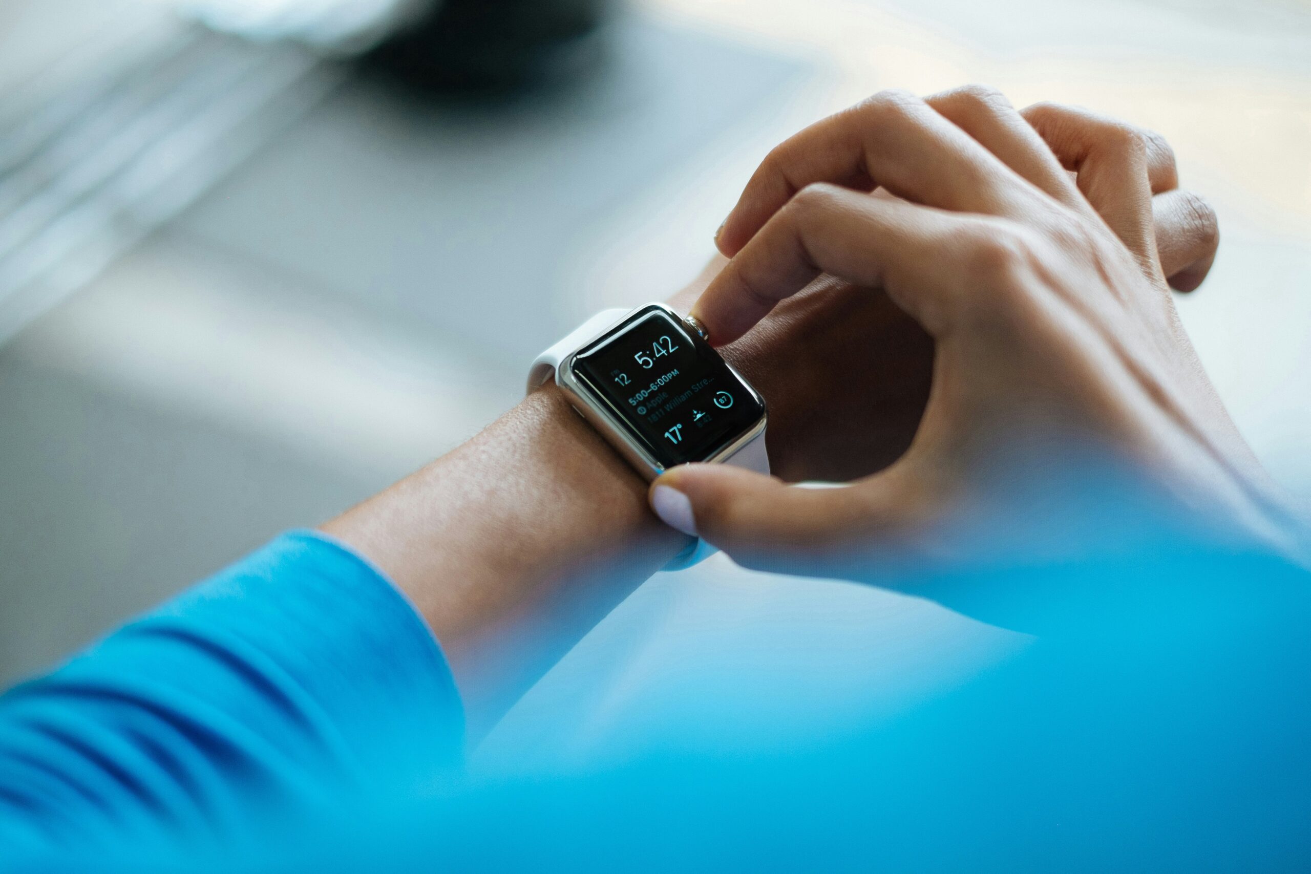 A female holding the controls and checking the readings on her fitness watch